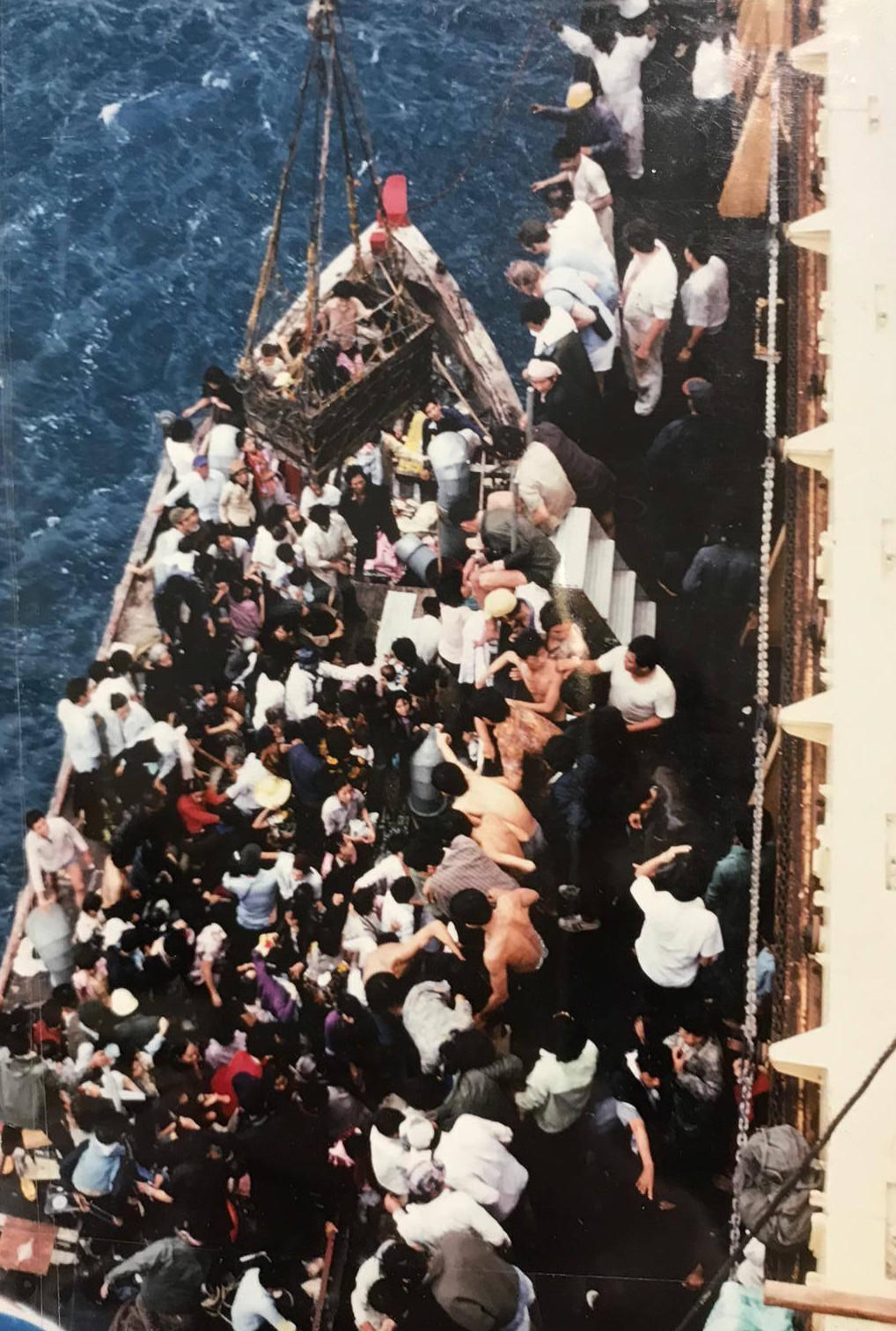 A packed boat being rescued by British sailors of the SS Sibonga on 21 May 1979
