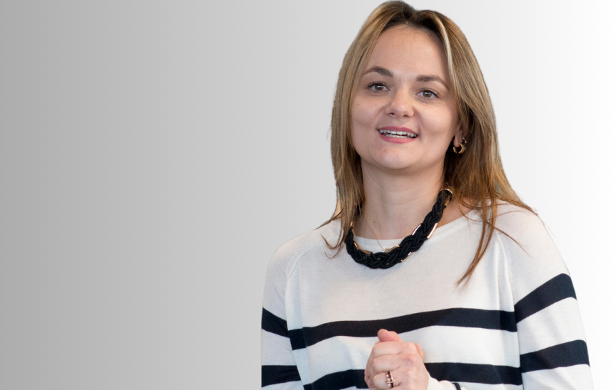 A young woman in a black and white jumper.